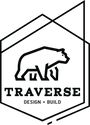a company logo with a bear traversing